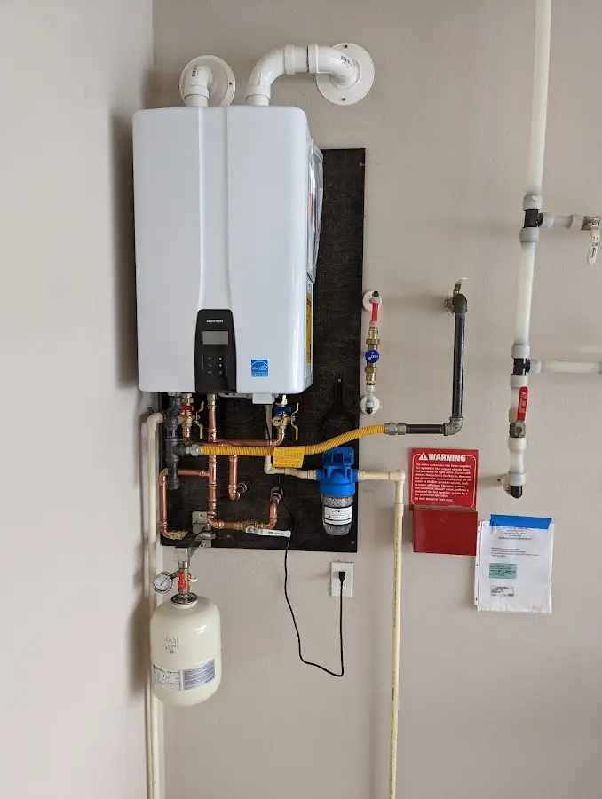 Professional plumber installing copper piping in a Glenwood Springs home